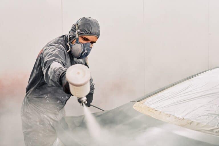 a man working with a suite and mask painting