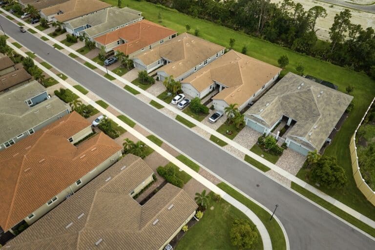 Aerial view of tightly packed homes in Florida closed living clubs. Family houses as example of real estate development in american suburbs.