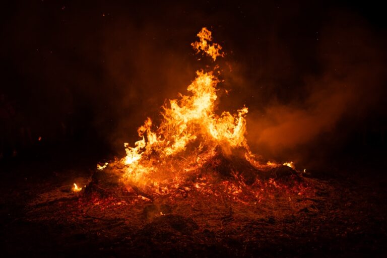 Big pile burning in the middle of the field.