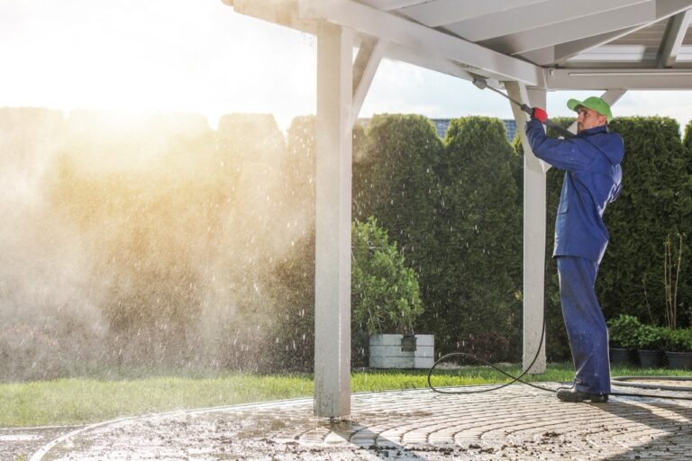 House Patio Roof Power Cleaning. Caucasian Worker with Pressure Washer.