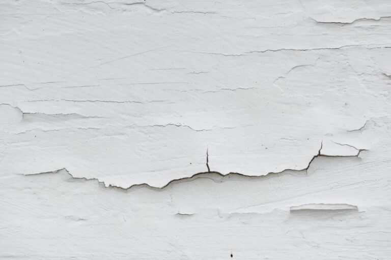 Cracked white paint on plank surface, abstract wooden background