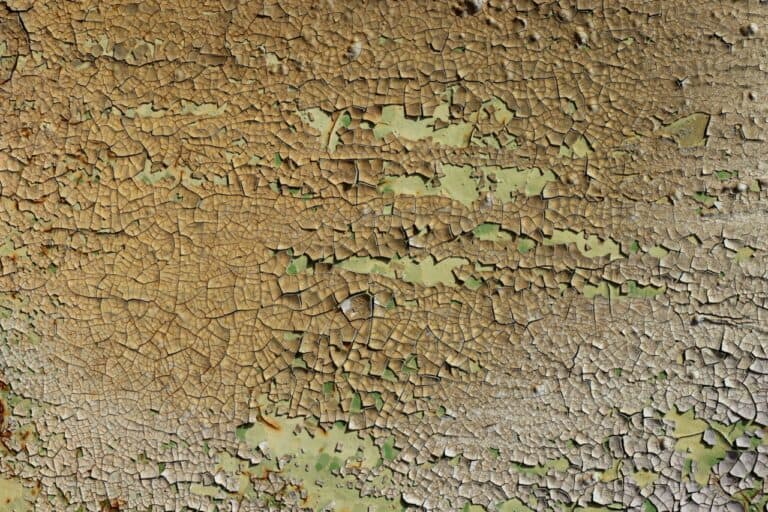 Detail of the flaking paint from the used metal surface