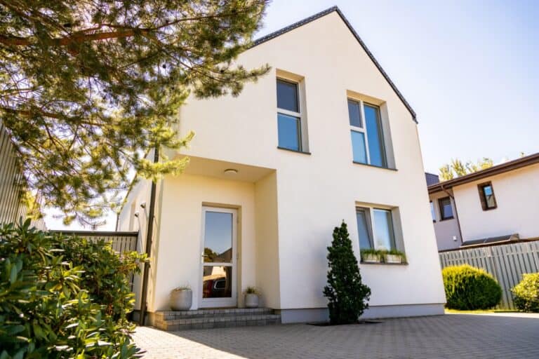 Outside view of a simple private white contemporary house in a residential district