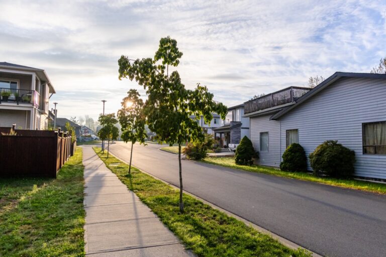 Peaceful residential street in Mission, BC, Canada features contemporary homes, lush greenery, and a sunny morning atmosphere. Ideal representation of suburban living.
