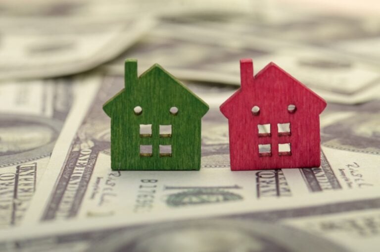 the colorful houses and the currency evokes the financial realities of the real estate market.