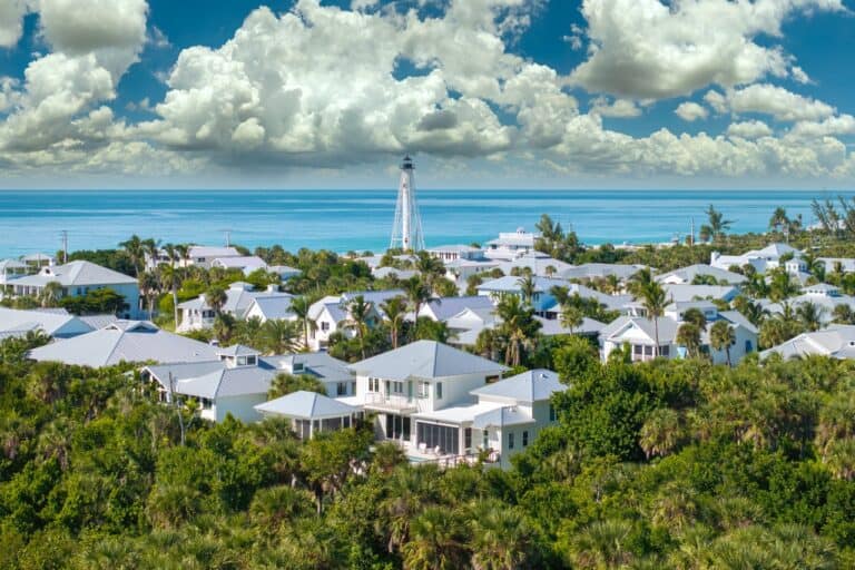 Wealthy waterfront residential area. Rich neighborhood with expensive vacation homes and white lighthouse in Boca Grande, small town on Gasparilla Island in southwest Florida.